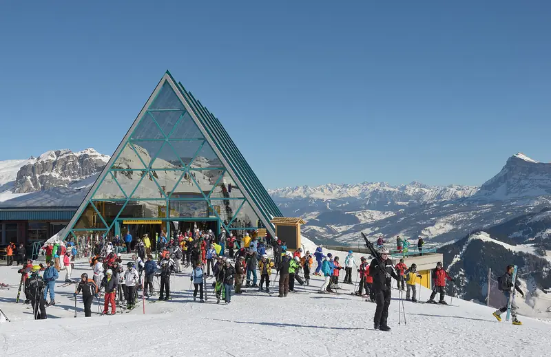 The Boè top station in Alta Badia with skiers and a view of the Dolomite peaks