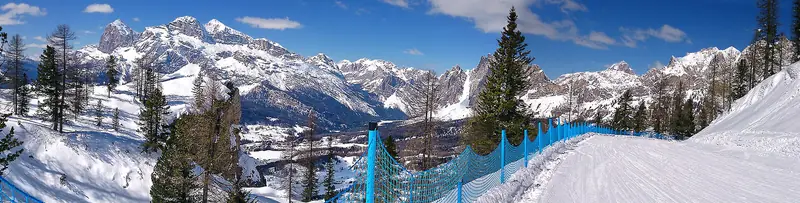 Snowy slopes and a lift below the Tofane at Cortina d'Ampezzo, the snow-dusted Dolomite peaks