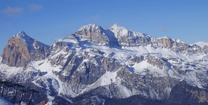 The snow-covered Tofana massif above Cortina d'Ampezzo under a blue sky