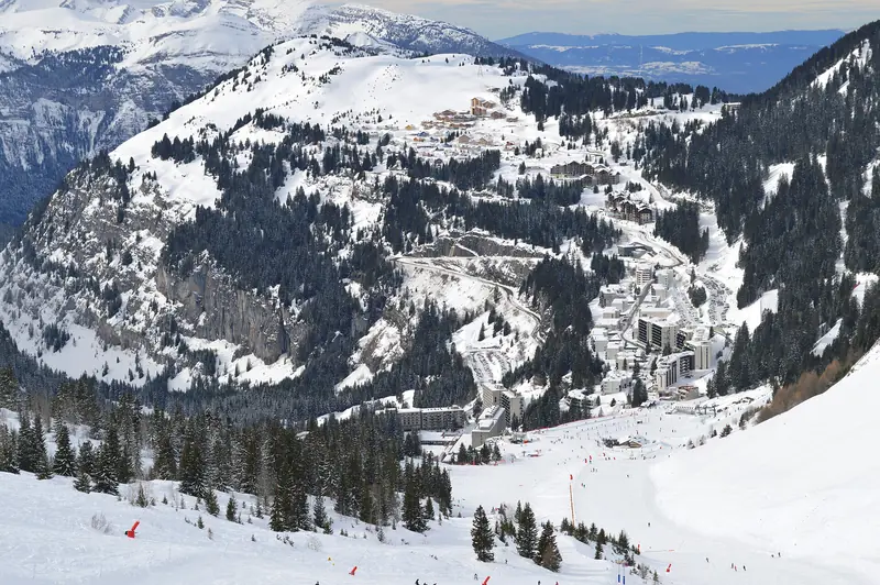 The Flaine resort on its slope in winter, pistes and lifts dropping toward the valley